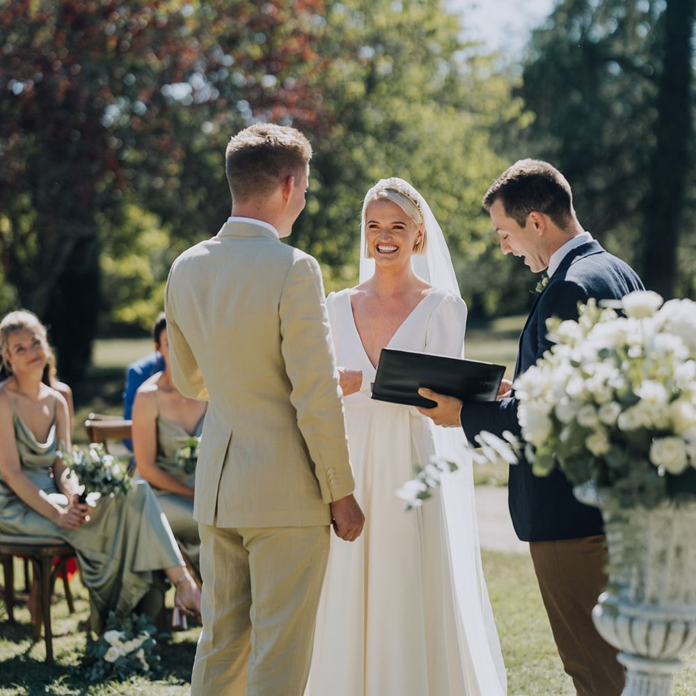Bride and groom exchanging wedding vows at outdoor destination wedding in a chateau 