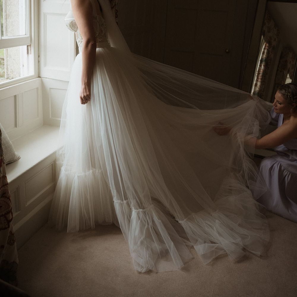 Bride in stunning tulle wedding dress with corset style top 