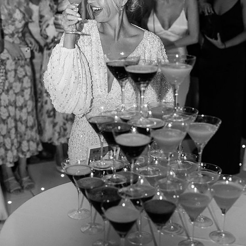 Bride with espresso martini tower during party by Romy Lawrence Photography