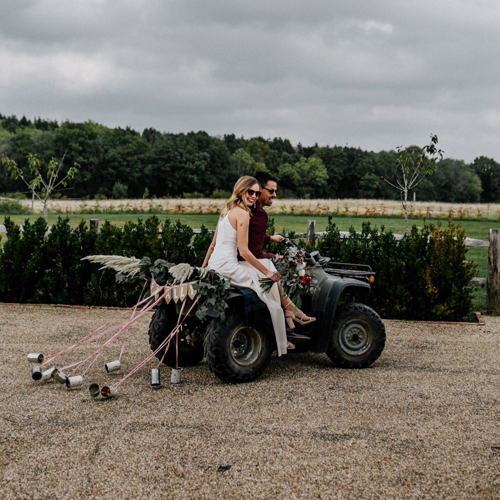 Micro wedding with bride and groom riding a quad bike