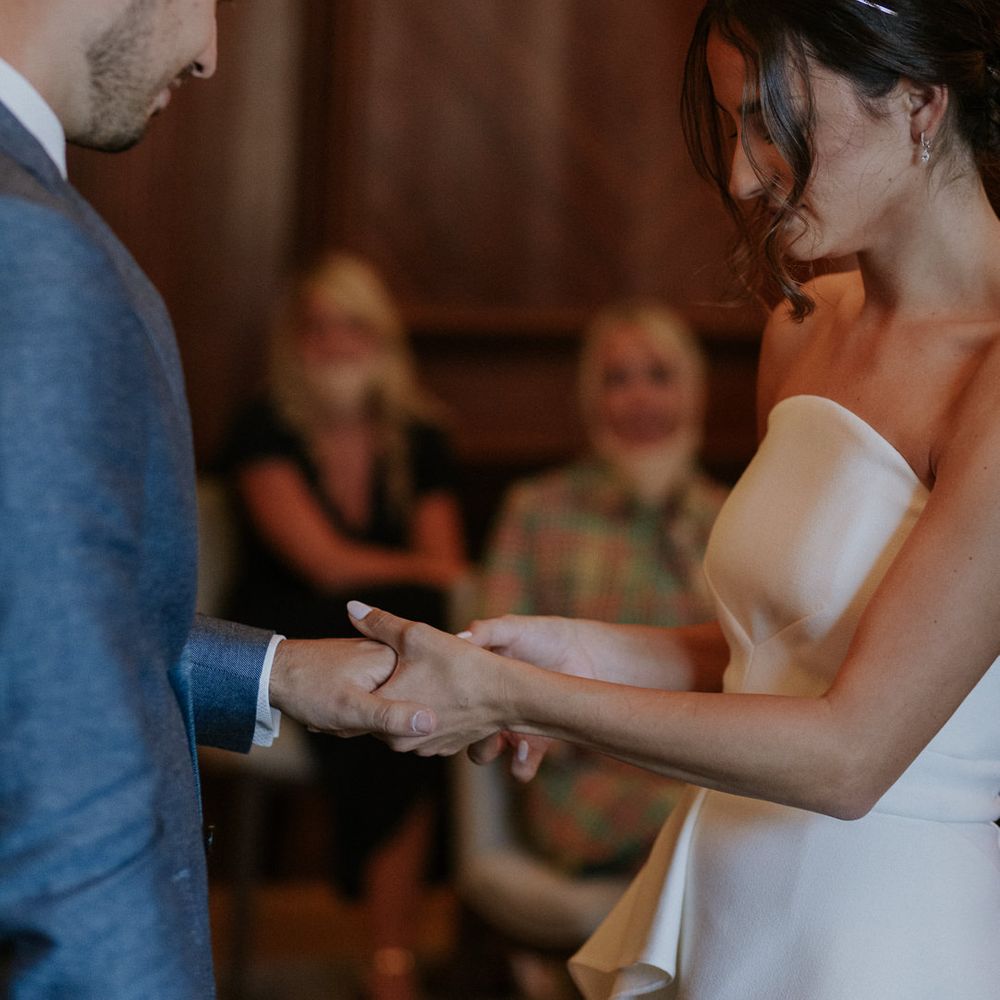 Bride and groom exchanging rings at socially distanced micro wedding
