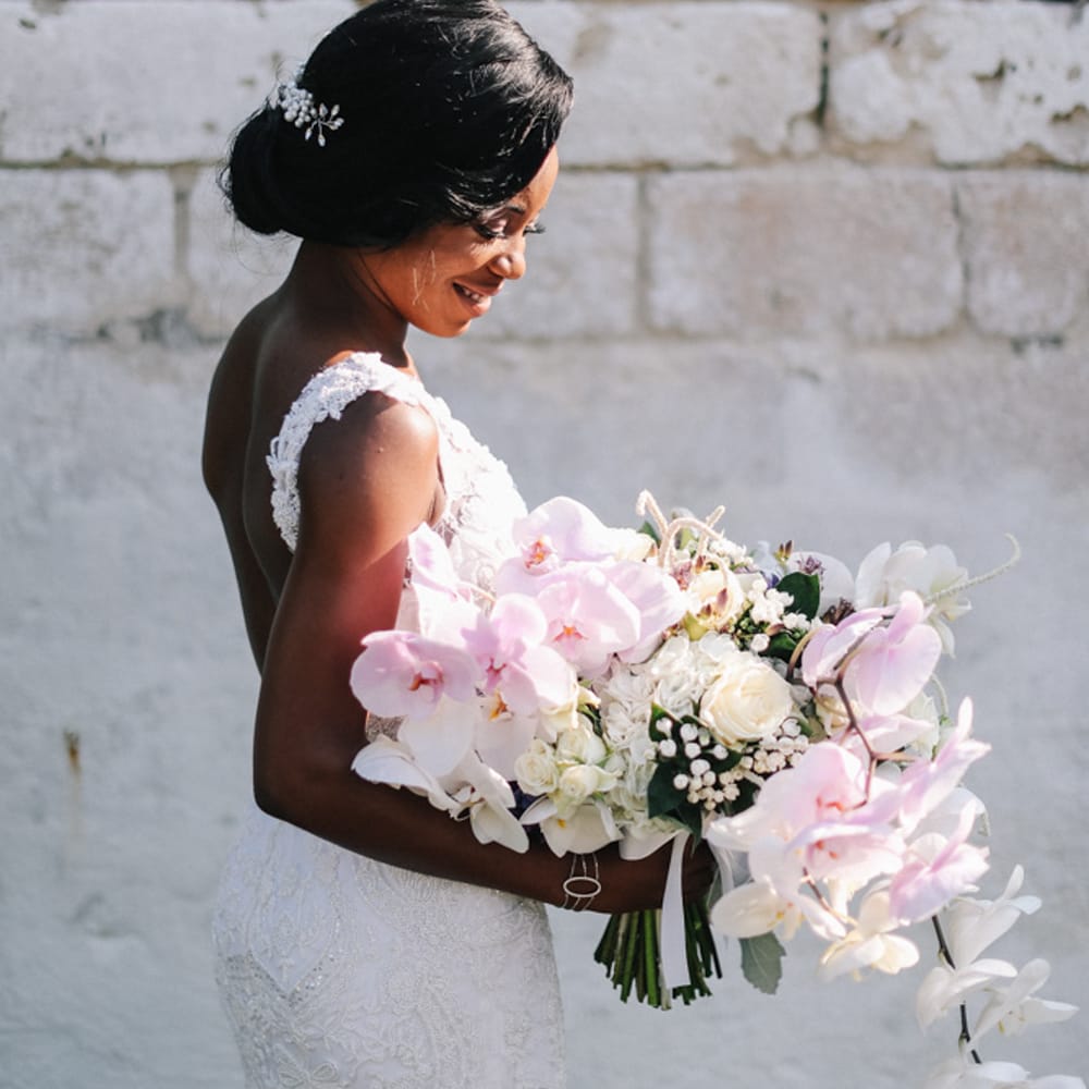 Beautiful bride holding wedding bouquet for Italian Wedding