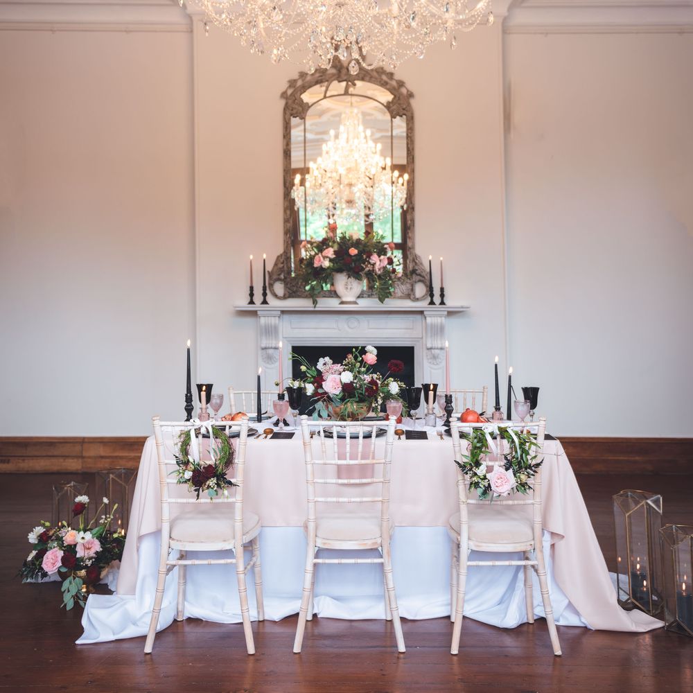 Intimate wedding reception decor at Thicket Priory country house with black, pink, white and red colour scheme 