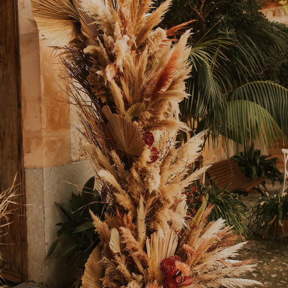 Pampas grass installation complete with bright florals throughout