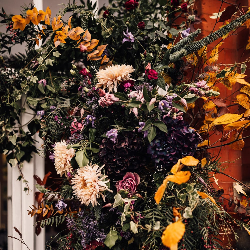 A mixture of autumn coloured flower arrangement 