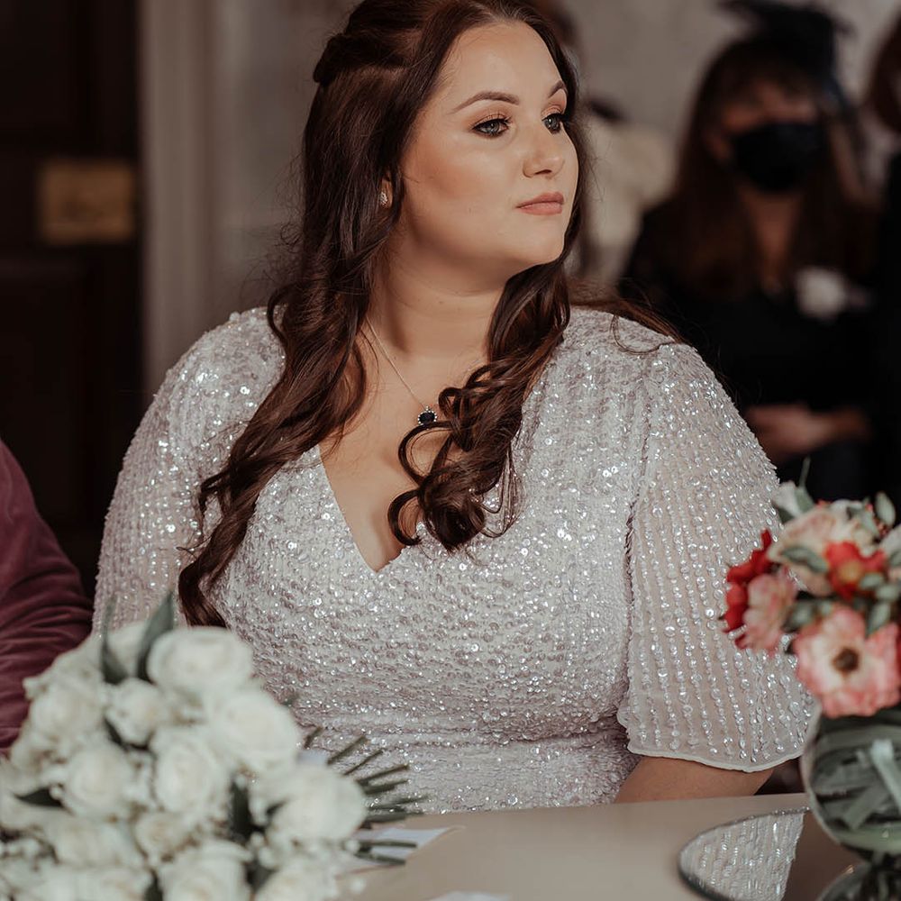 Bride wears her brown hair in loose curls on her wedding day