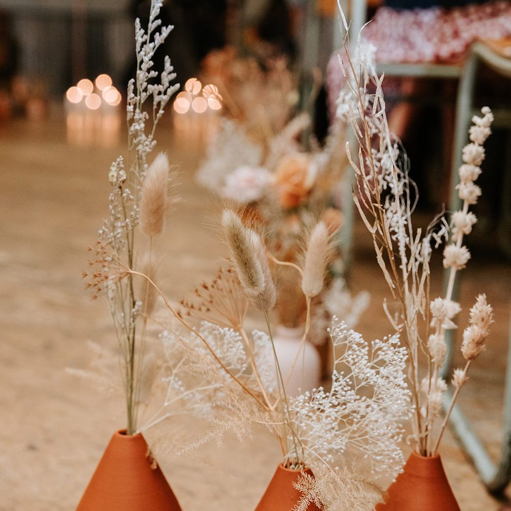 Handpainted terracotta vases with dried flowers for autumnal wedding decor