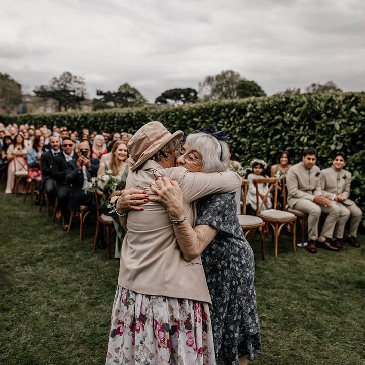 Outdoor multicultural wedding ceremony with a Milni ritual - joining of two families by swapping garlands