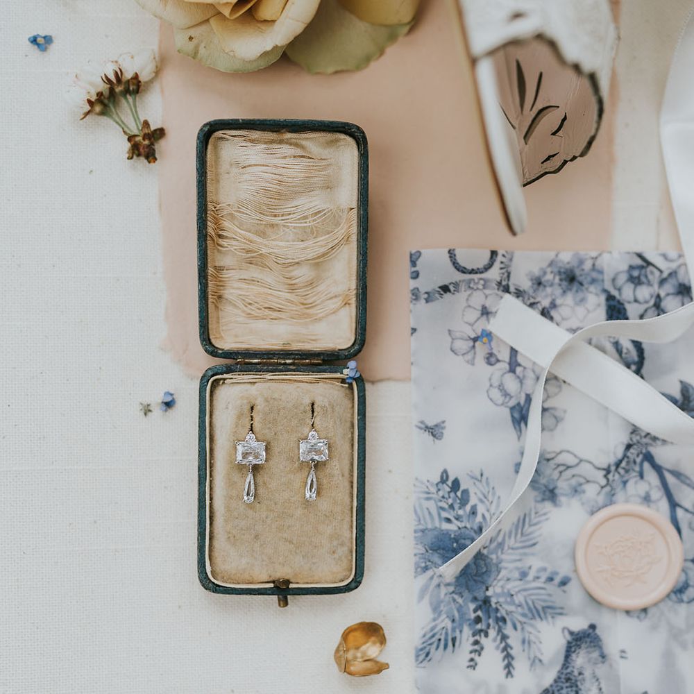 Diamond earrings with with blue and white stationery with wax seal