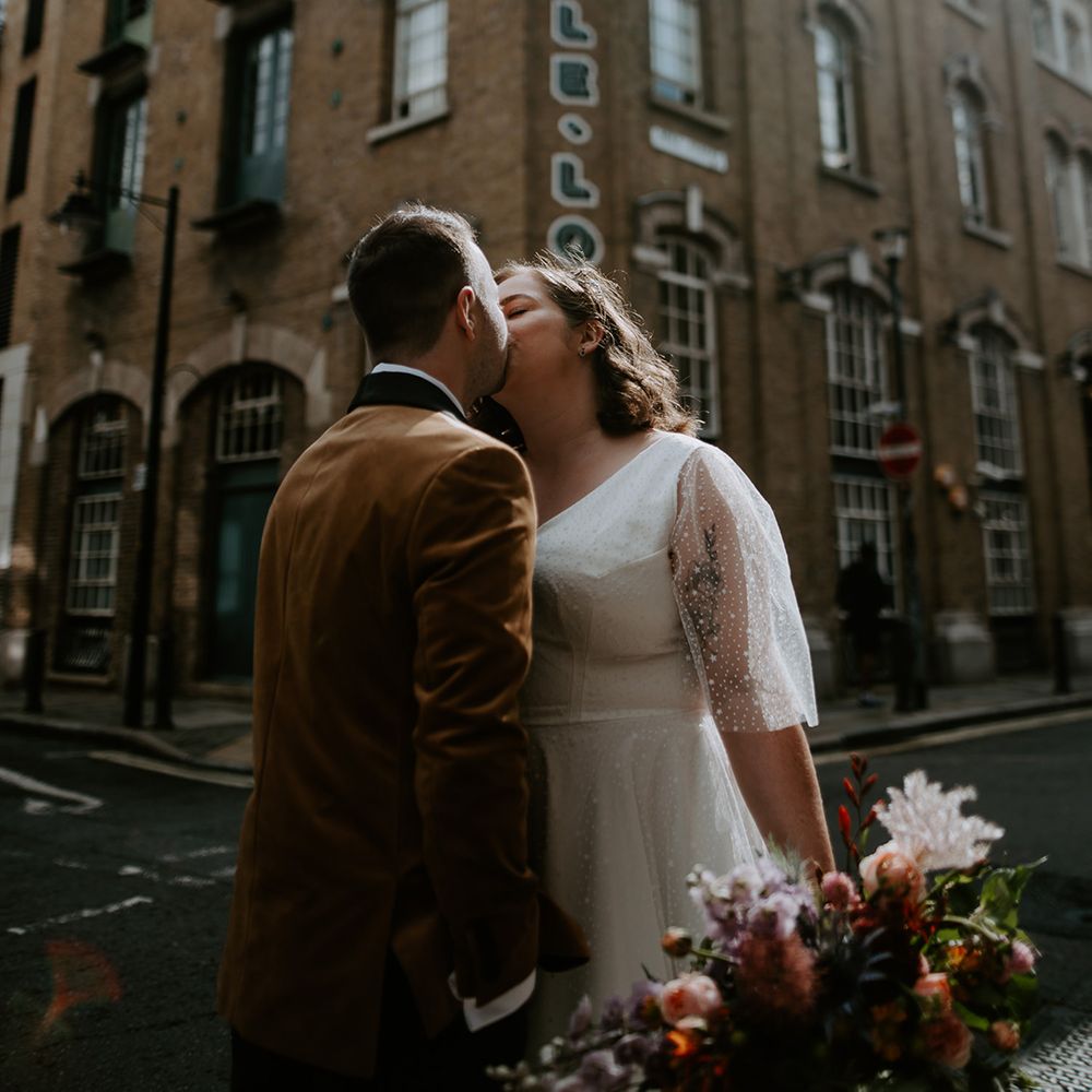 Bride and Groom kiss in the streets at London Wedding