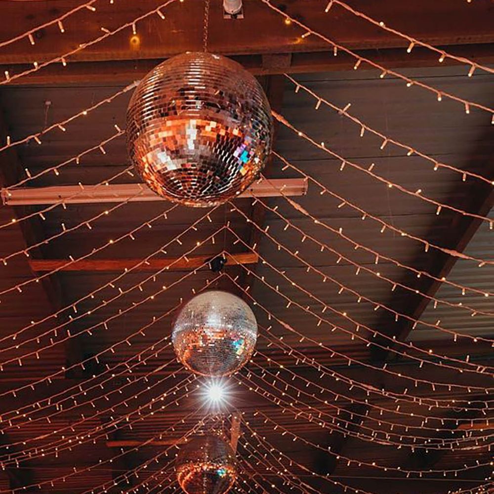 Image of disco ball and fairy lights decoration on the ceiling by Amy Chapple Photography
