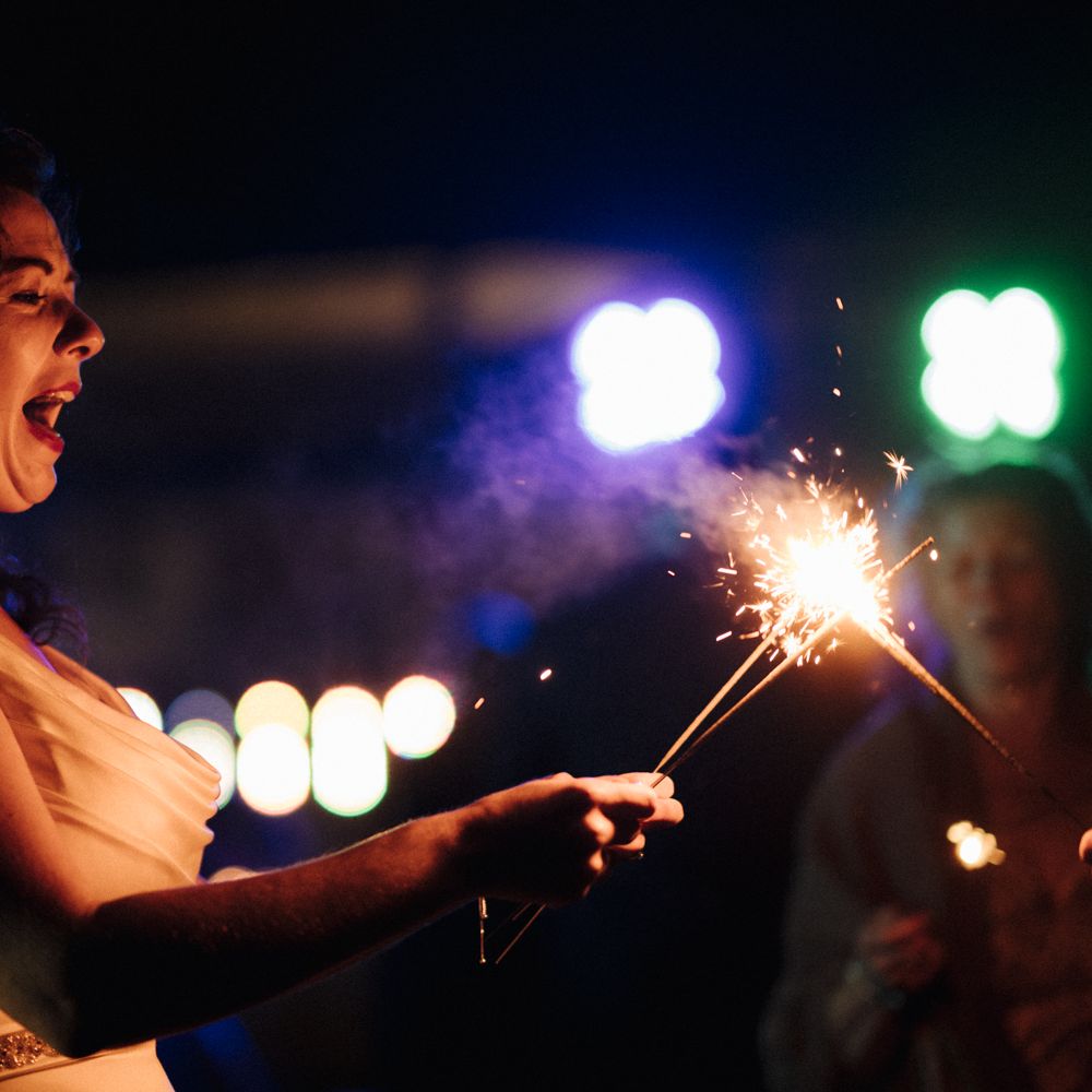 Bride with sparkler at wedding reception 