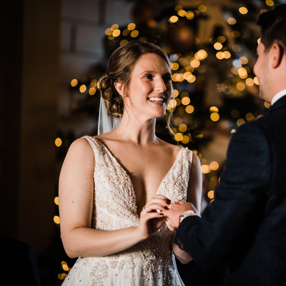 Bride & groom hold hands during wedding ceremony