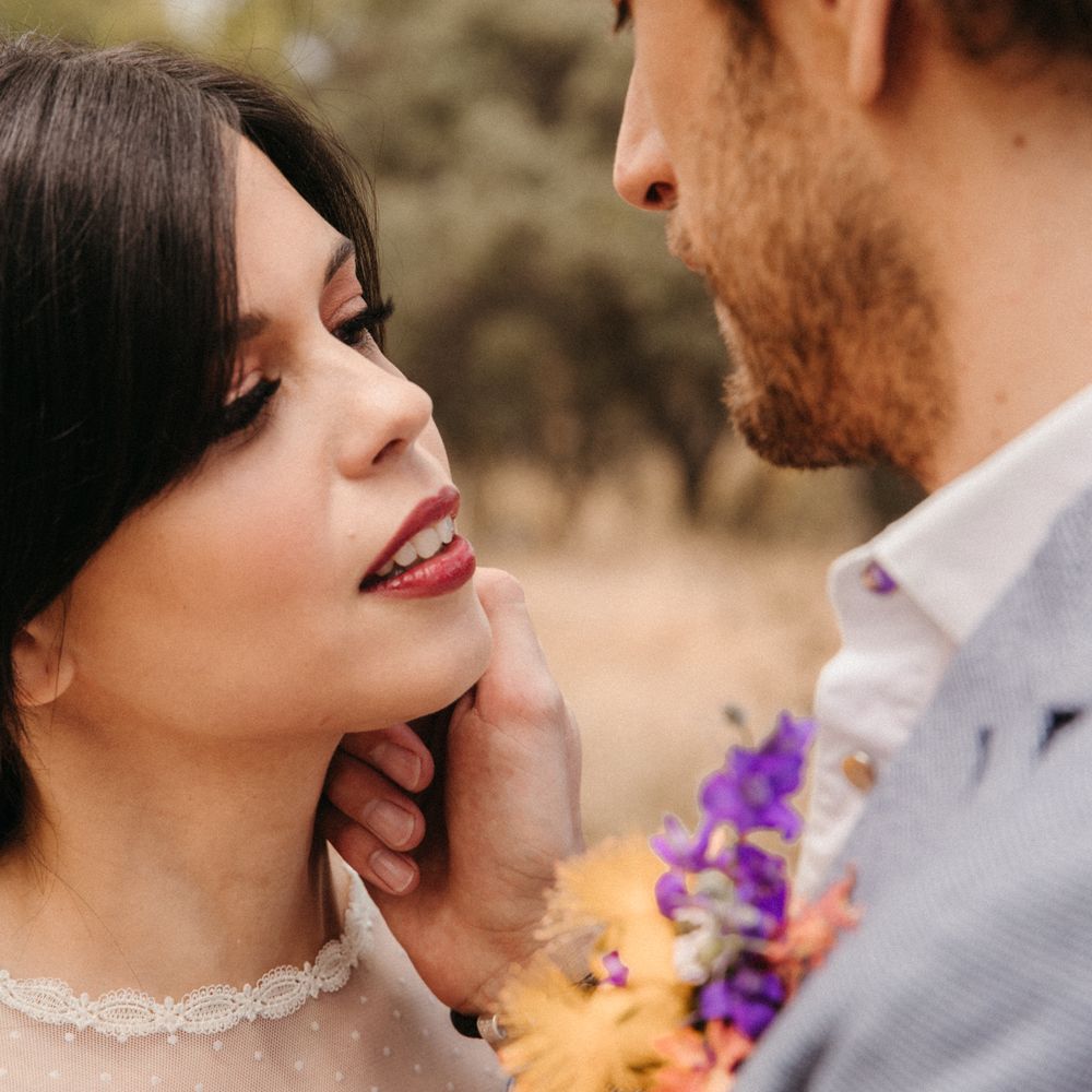 Groom caresses brides cheek during romantic Spanish elopement 
