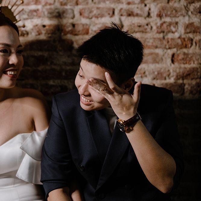 Portraits of two brides in a strapless wedding dress and crown and navy double breasted jacket 