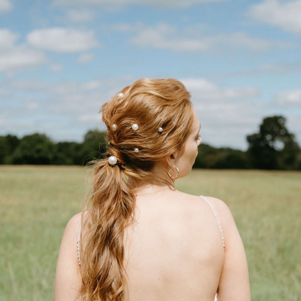 Relaxed bridal ponytail with pearl hair accessories