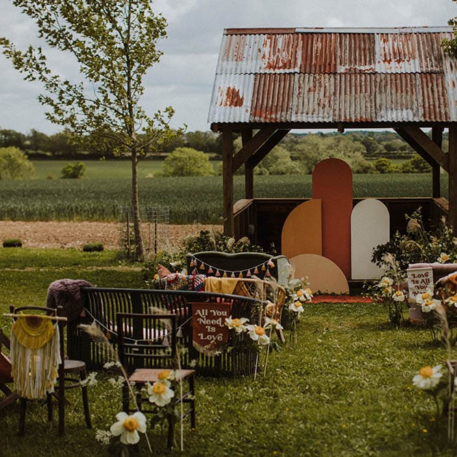 Sixties wedding inspiration with retro furniture, bold flowers, decor and signs