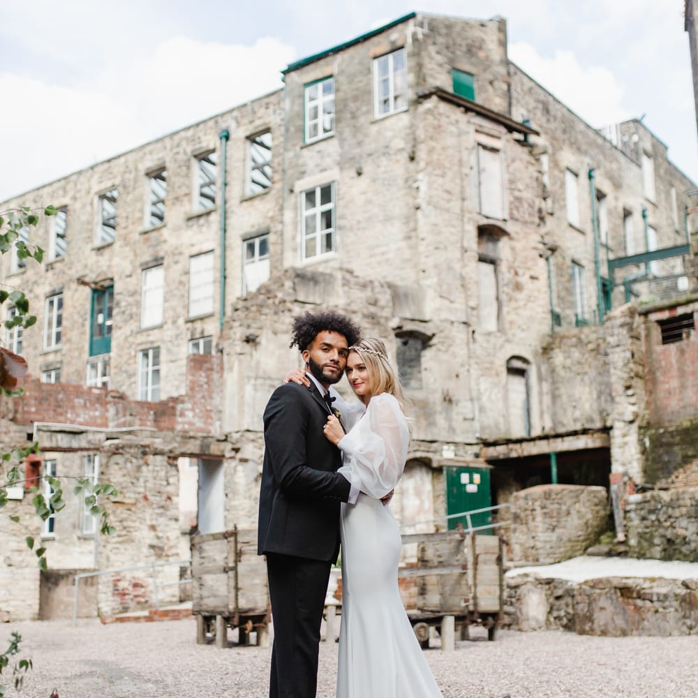 Bride and groom portrait in the courtyard at Torr Vale Mill, Derbyshire 
