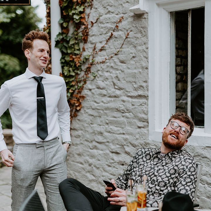 Wedding guests gather outside pub for reception