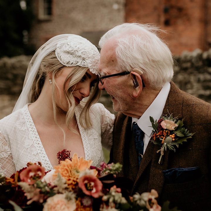 Bride in a lace wedding dress and Juliet cap veil with her grandfather in a brown wool suit 