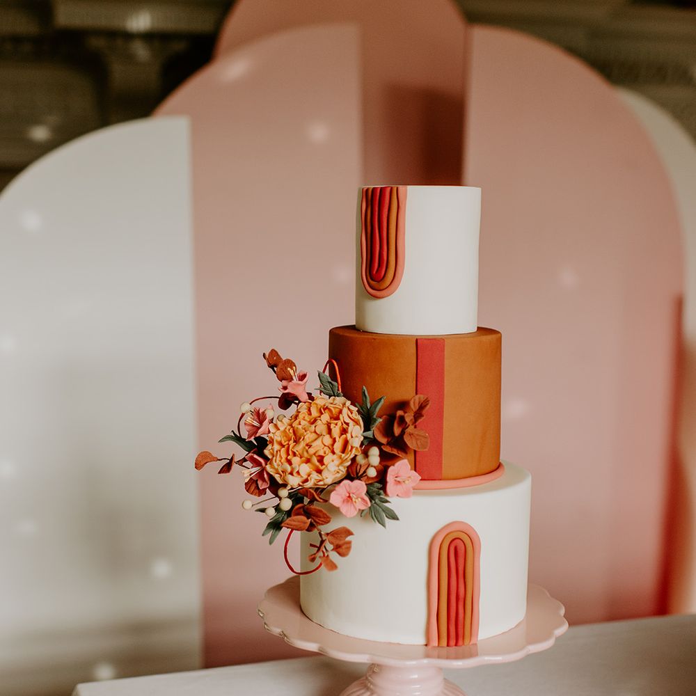 Iced retro wedding cake with orange layer and geometric design 