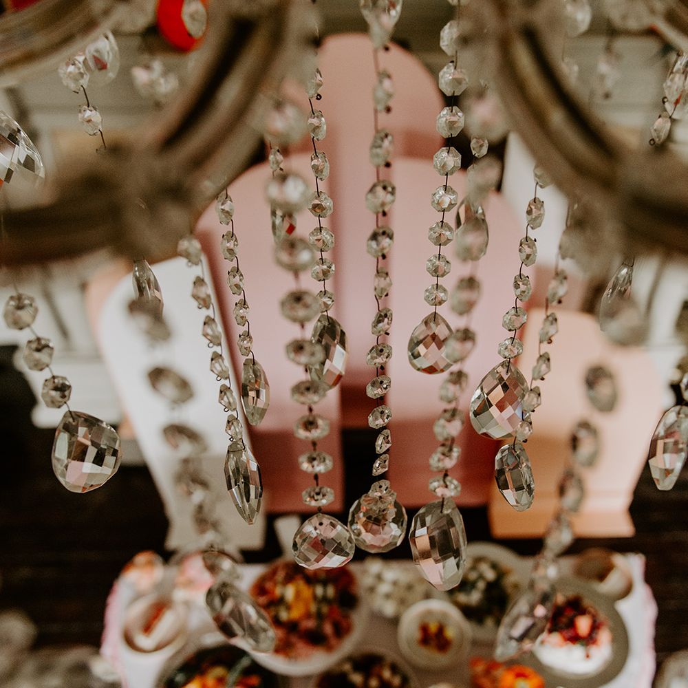crystal chandelier hanging over the food table at retro wedding 