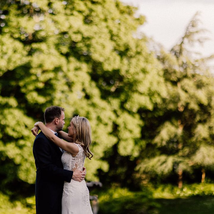 Bride and groom share a private moment together as they look out over the gardens at Goldney Hall 
