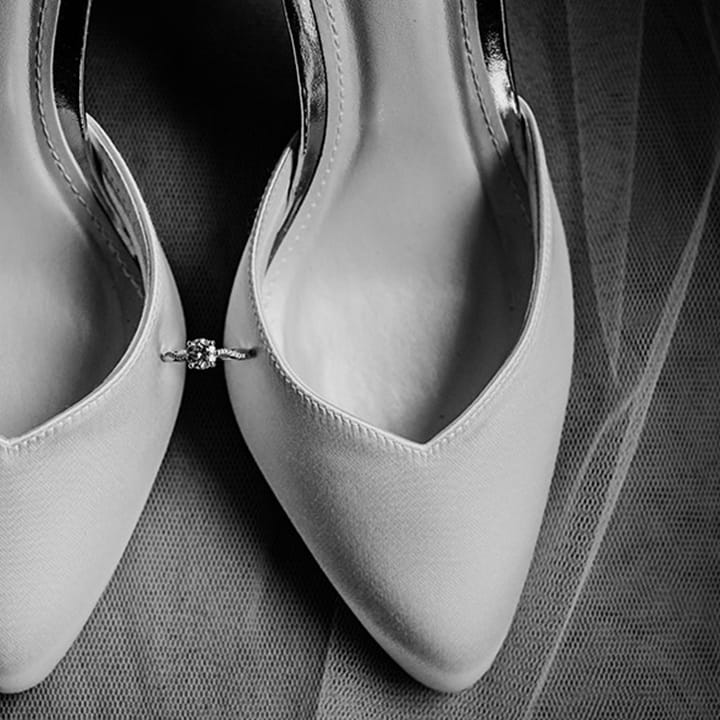 White wedding heels from Rainbow Club with the bride's brilliant round engagement ring