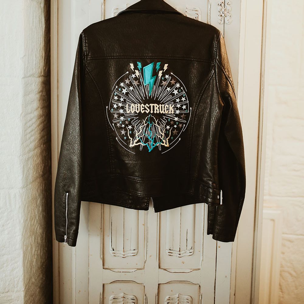 Personalised leather jacket with 'Lovestuck' written across the back within colourful silver design