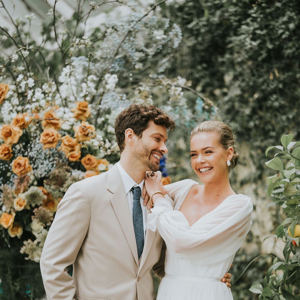Bride and groom laugh together for their romantic wedding at Sezincote House