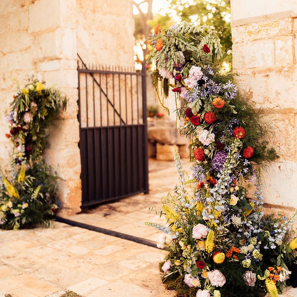 Bright and colourful summer flower columns line the entrance