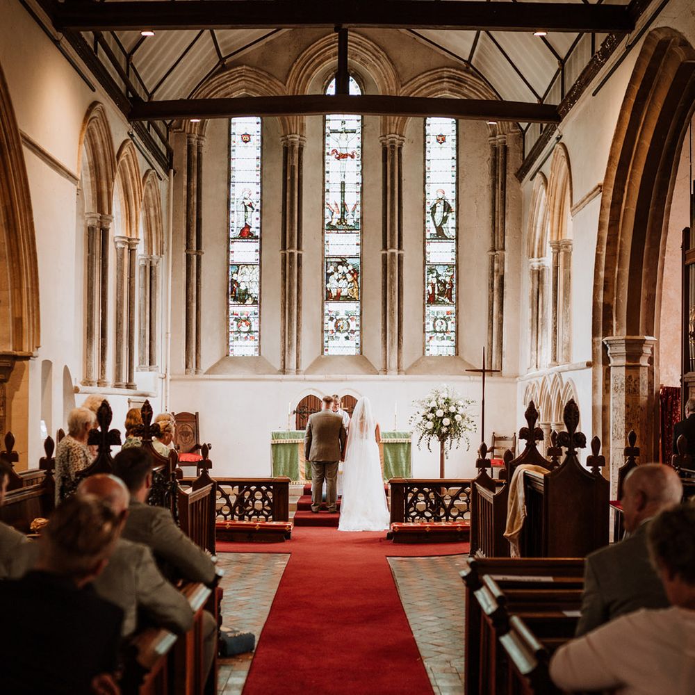 Bride and groom stand at the altar for their church wedding ceremony 