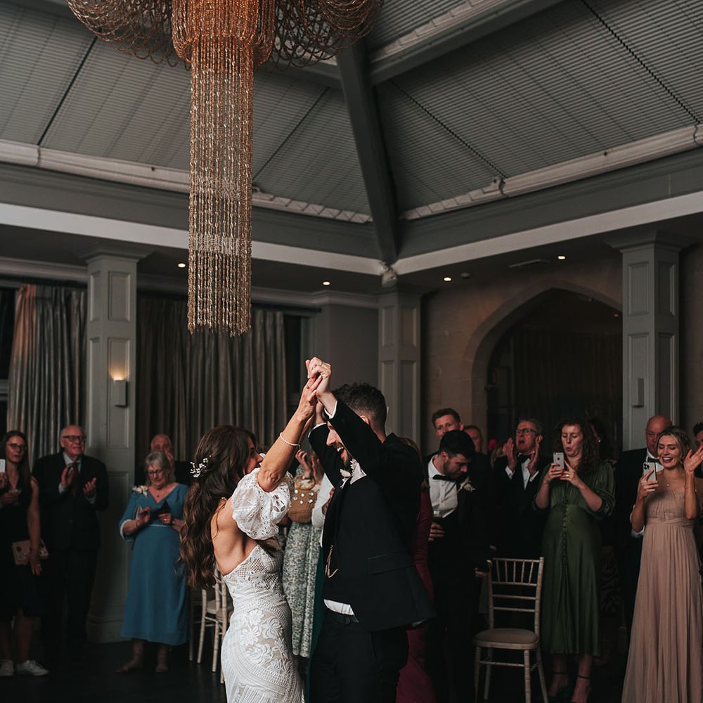 The bride and groom have their first dance together 