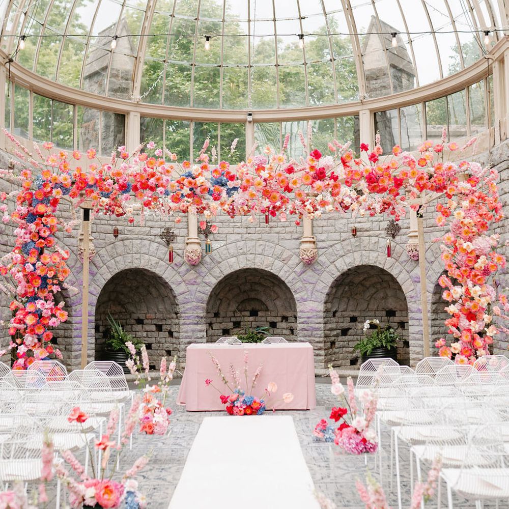 De Vere Tortworth Court wedding venue glass house wedding venue with bright pink wedding flowers for Moroccan theme wedding 