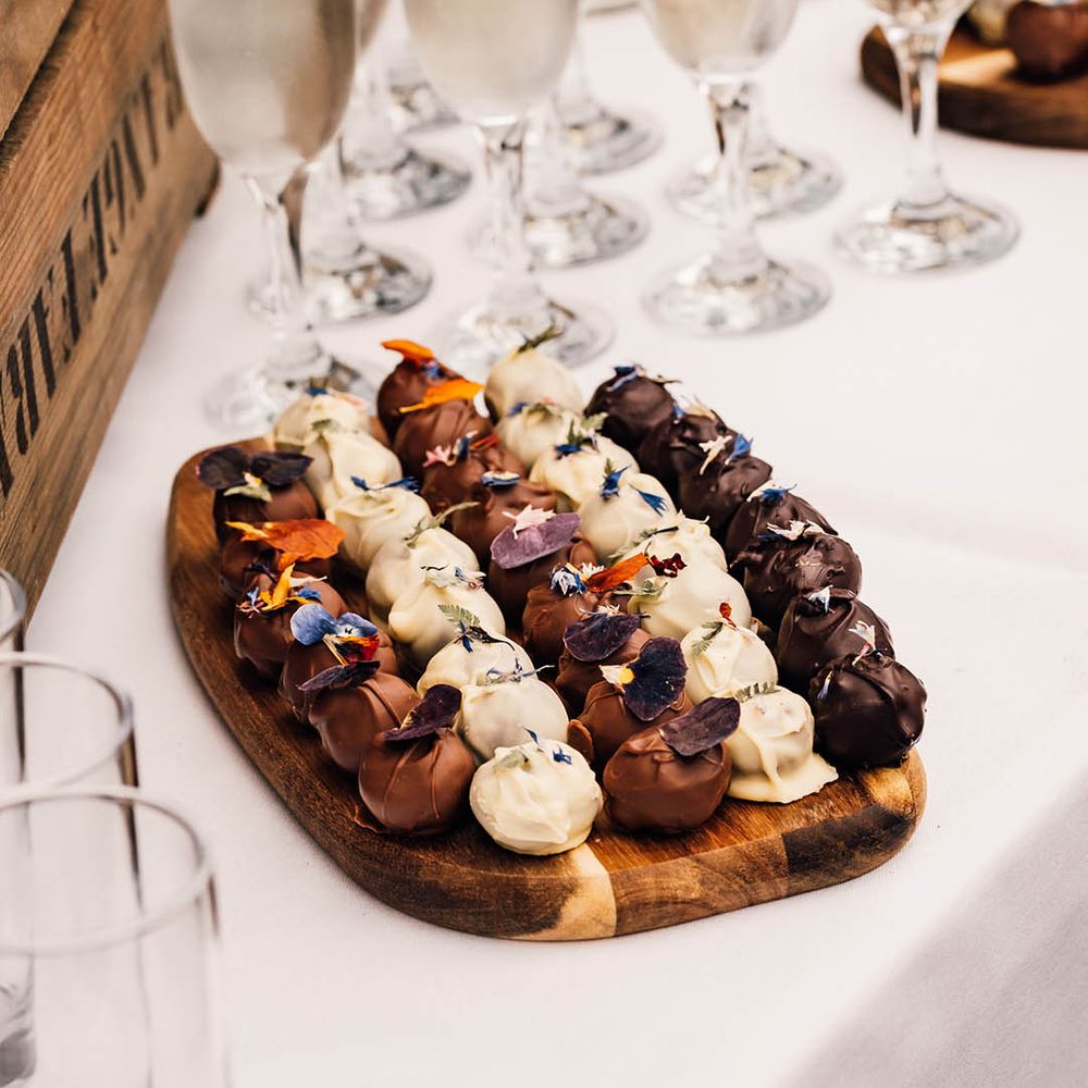 Platter of chocolate favours with edible flowers grown by the couple 