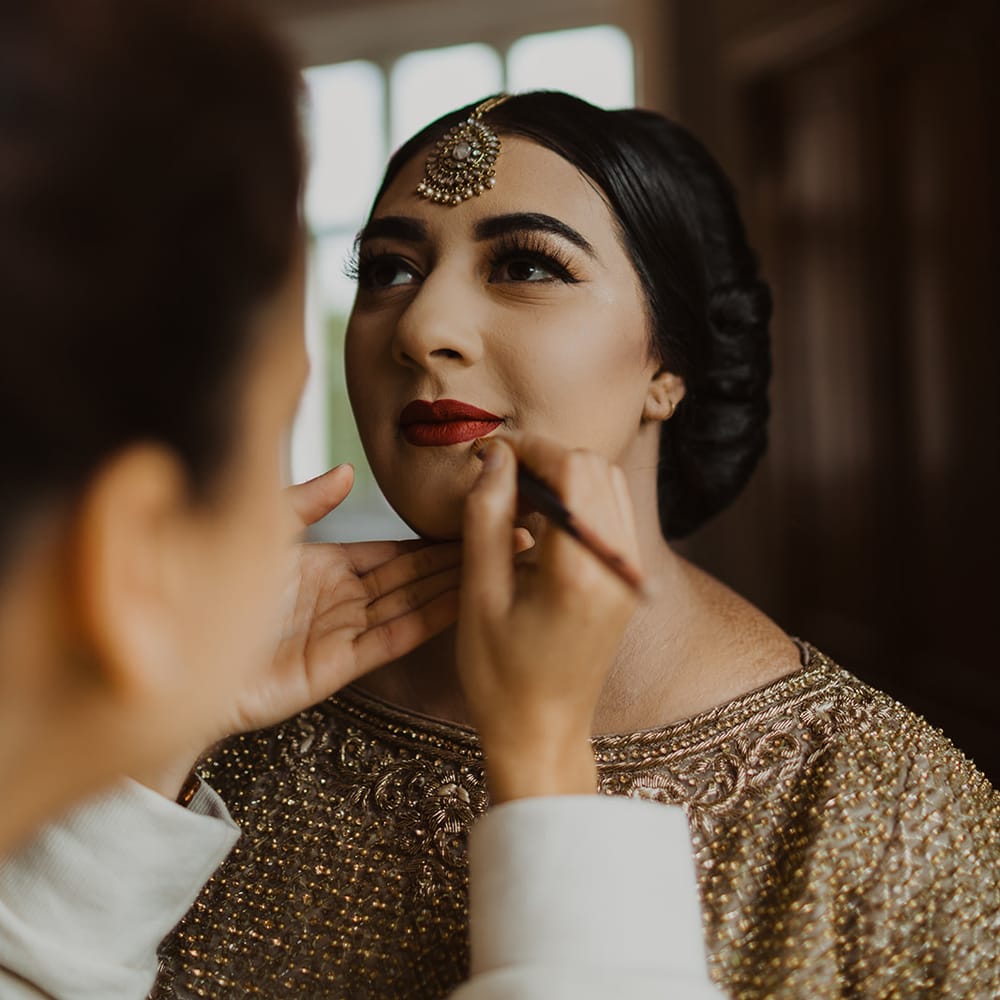 Muslim bride having her makeup done 