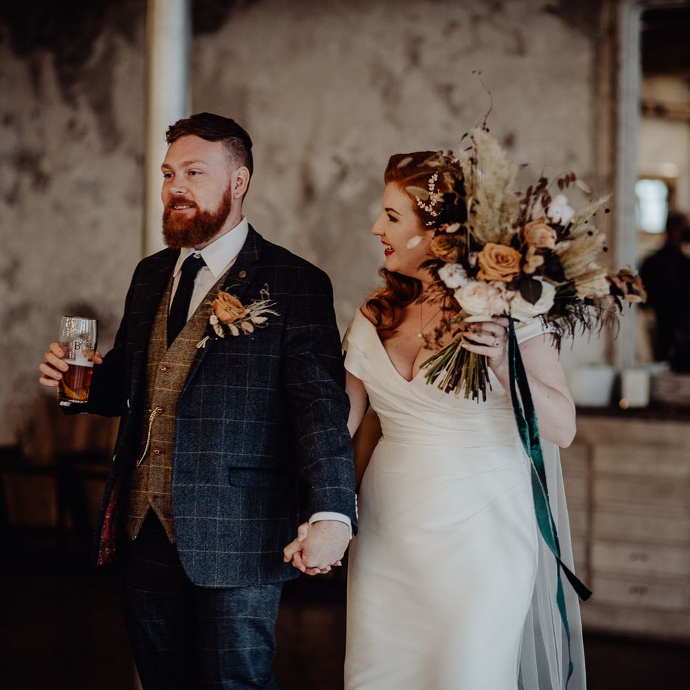Bride and groom holding hands at intimate Holmes Mill wedding 