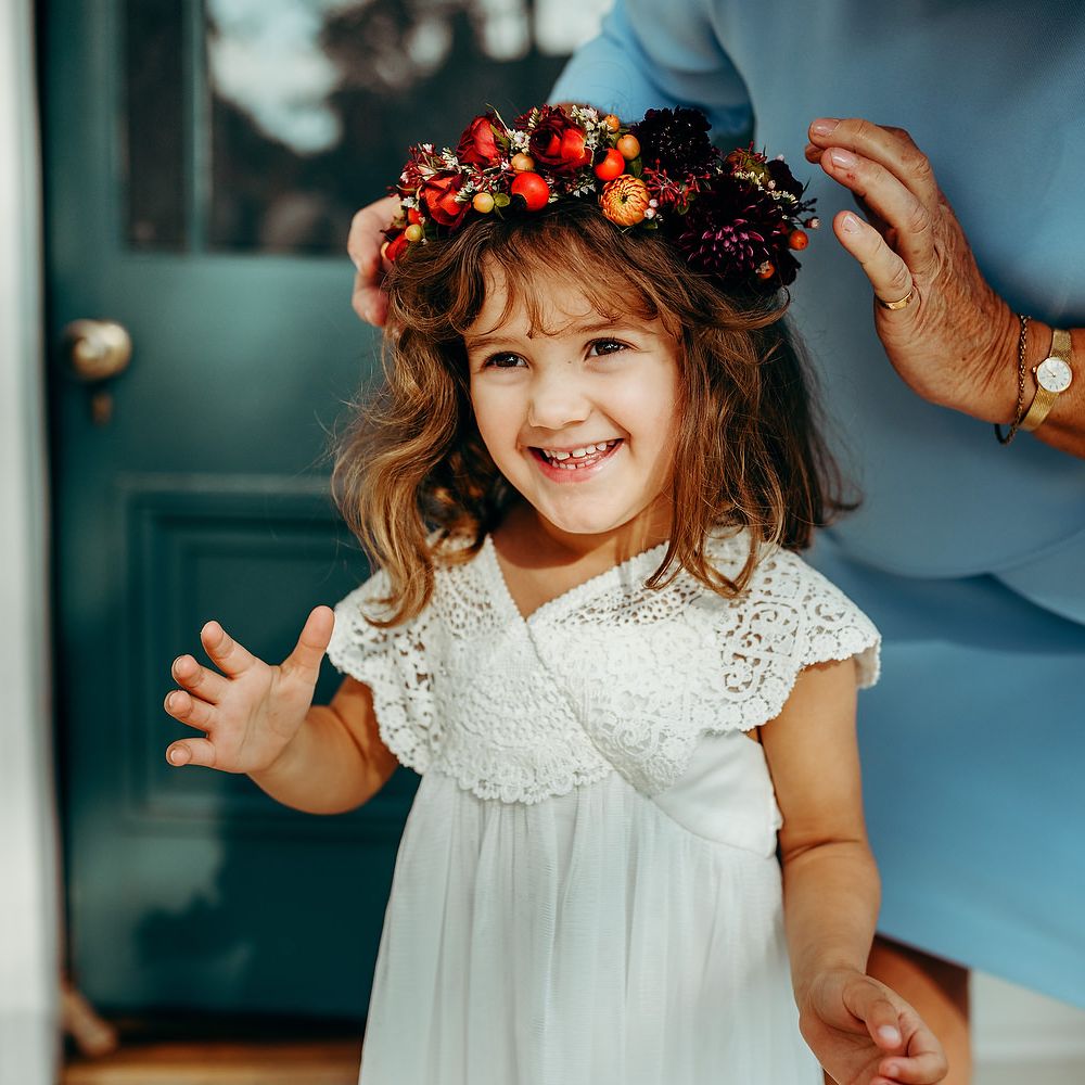 Flower girl wearing Autumnal coloured flower crown