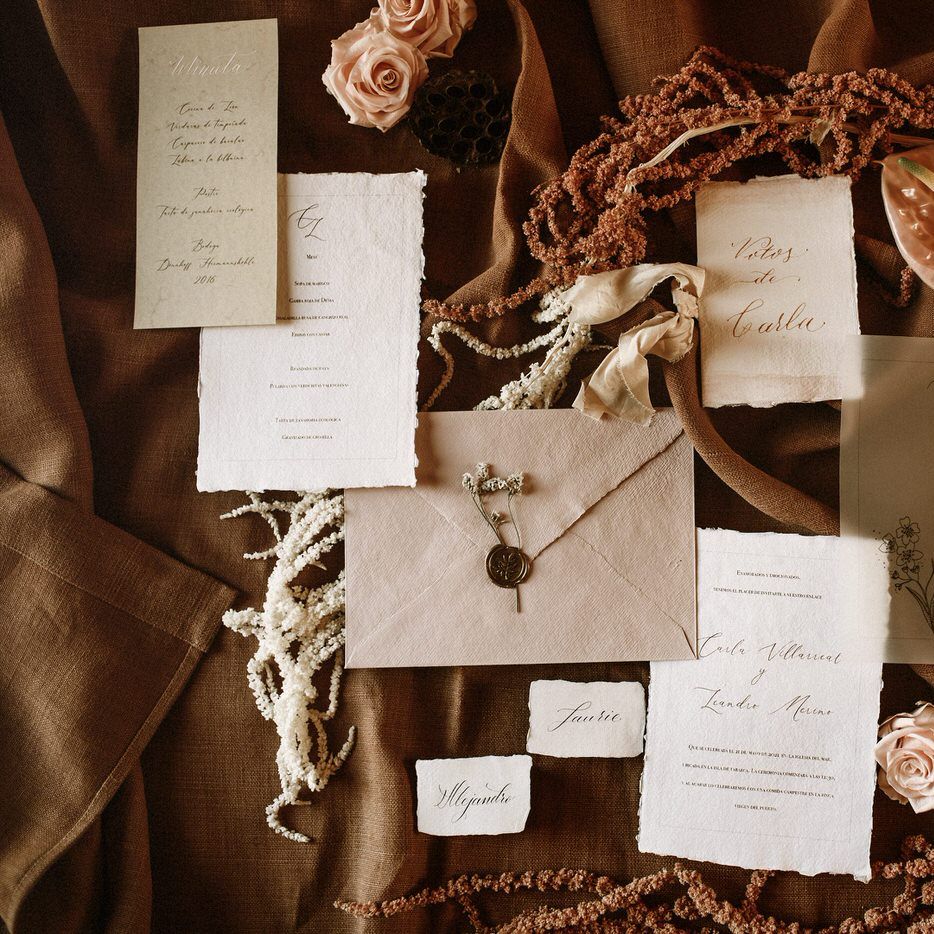 Romantic wedding stationery suite in natural tones with dried grasses and anthurium decor 