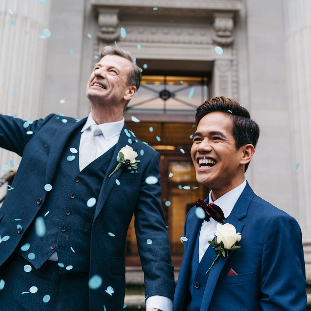 Grooms laugh and celebrate after wedding ceremony