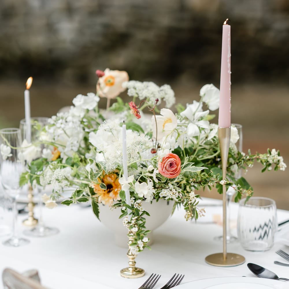 Elegant floral arrangement with ranunculus, anemones and foliage 