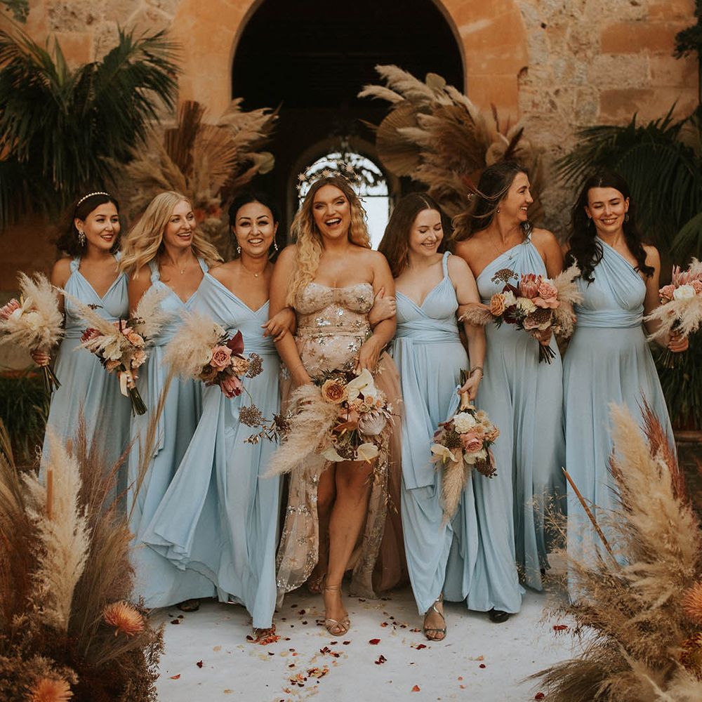 Bride stands with her bridesmaids as she wears ethereal style gown and star crown