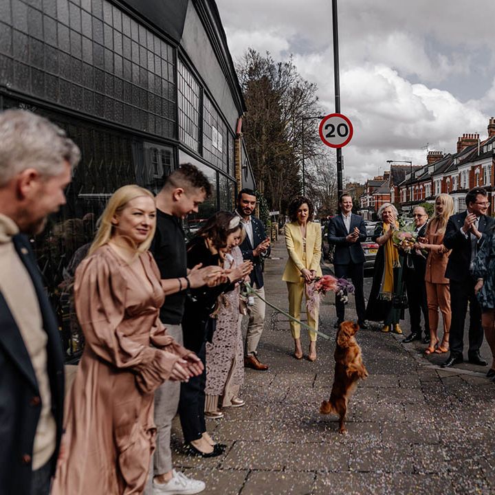 wedding guests lining up to do confetti exit at stylish London wedding 