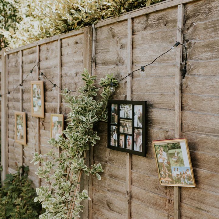 DIY wedding reception at home with homely photos in photo frames and fairy lights