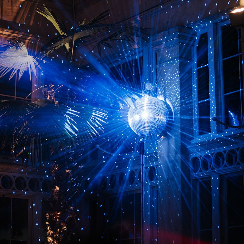 Brightly lit disco ball decor at Syon Park for wedding reception party