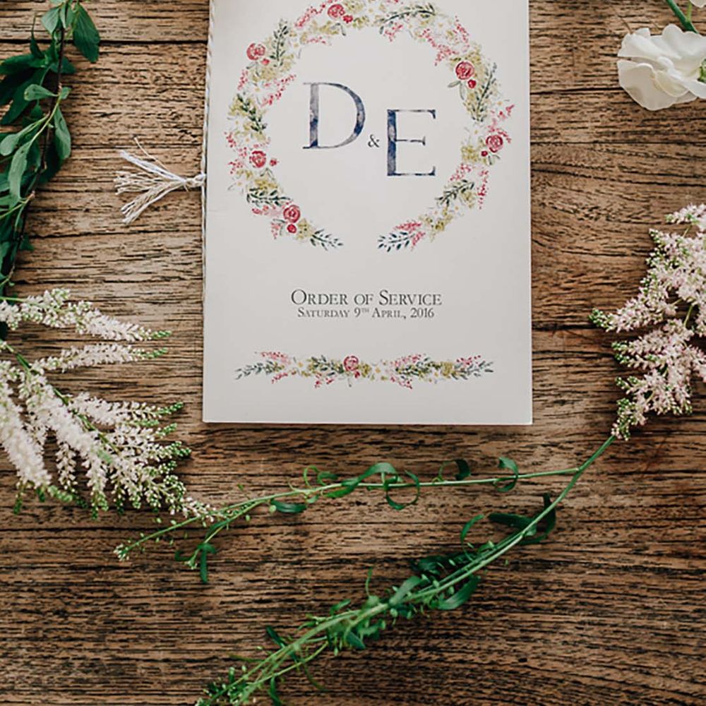 Floral design order of service card with white and green wedding flowers