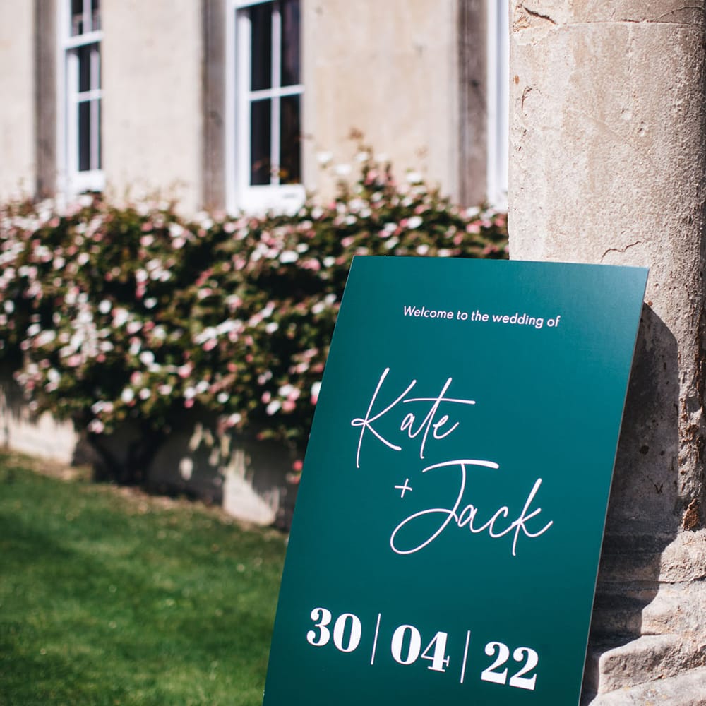Green and white wedding welcome sign for the contemporary wedding at Elmore Court wedding venue 