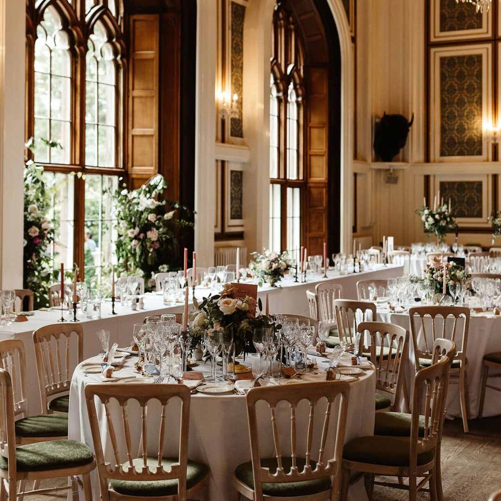 Reception room of Drumtochty Castle wedding venues Scotland with classic wedding tablescapes and chandeliers 