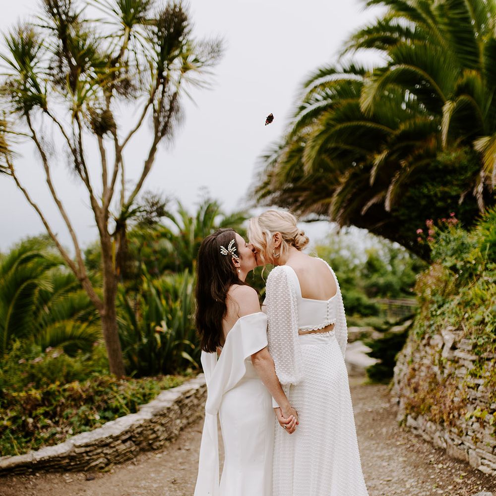 Brides in off the shoulder wedding dress and bride in two piece top and skirt for relaxed outdoor wedding 