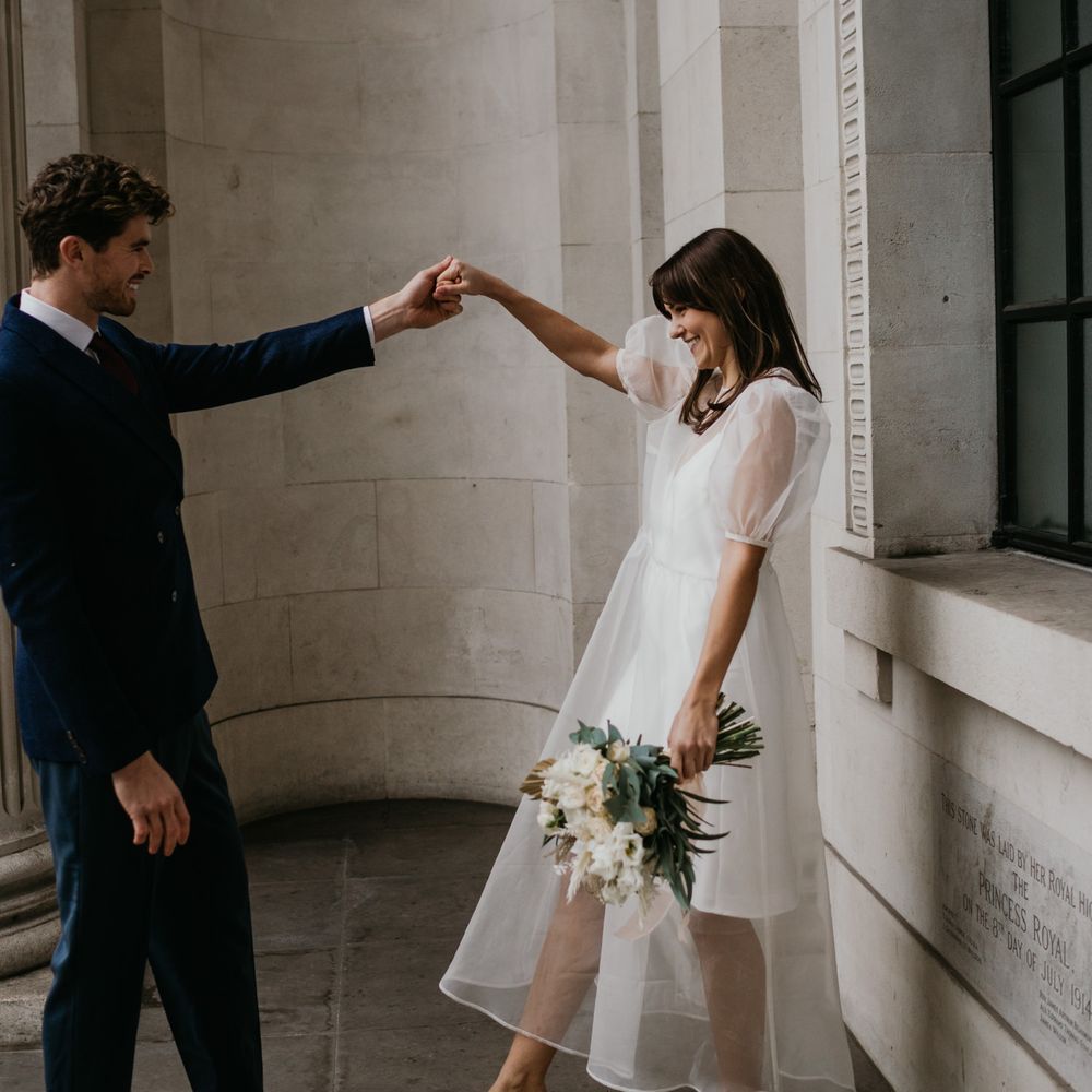 Bride and groom dancing at Intimate Old Marylebone Town Hall with Bride in Story Of My Dress gown